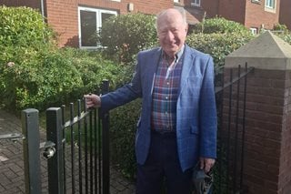 Professor James Hirshfield stands outside his McCarthy & Stone retirement community in Birmingham