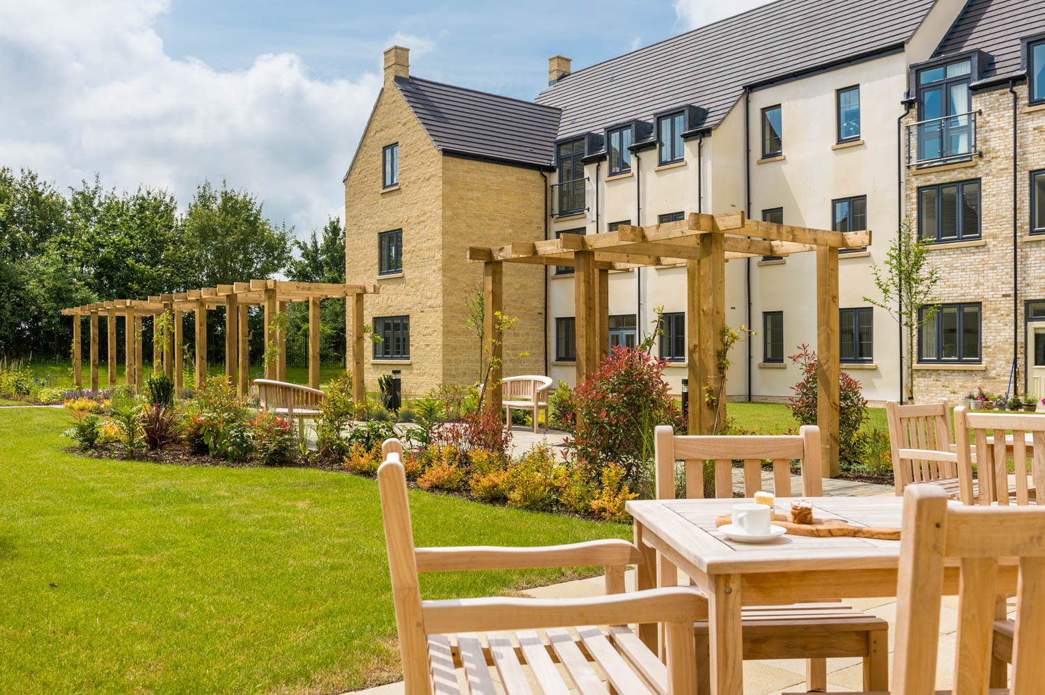 a group of tables and chairs outside a house