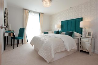 a bedroom with a bed and a chair
