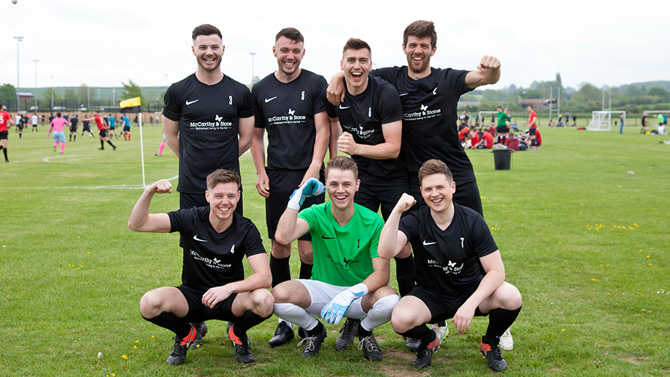a group of men posing for a picture on a field