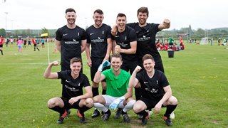 a group of men posing for a picture on a field
