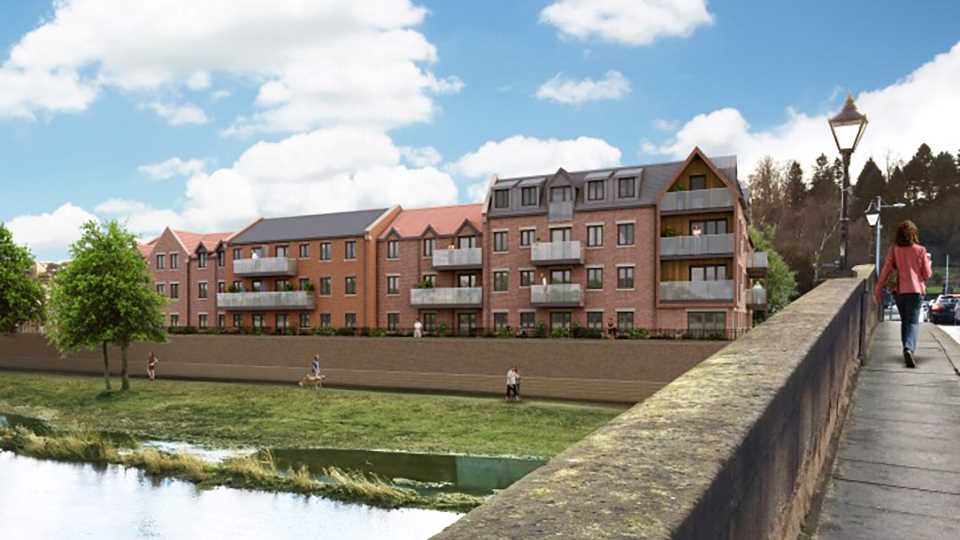 a brick building with a pond in front of it