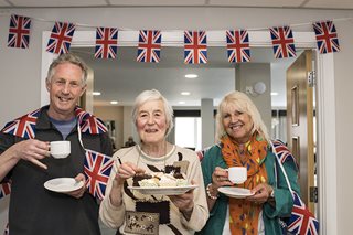 a group of people holding plates of food
