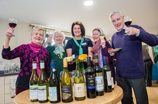 a group of people holding wine glasses