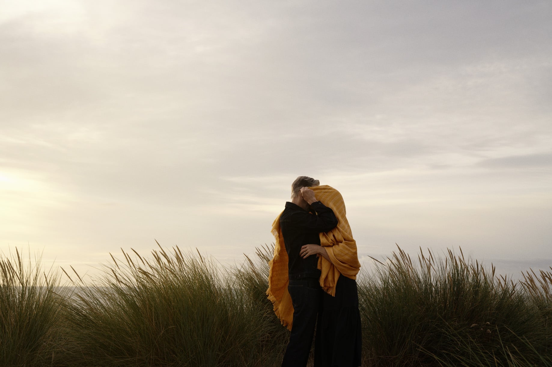 a man and woman kissing in a field