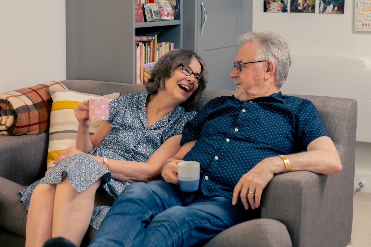 Mr and Mrs Gordon sitting on their couch