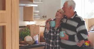 a man and a woman drinking from a green cup