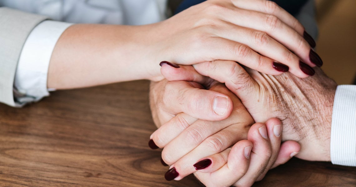 a pair of hands holding each other