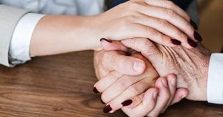 a pair of hands holding each other