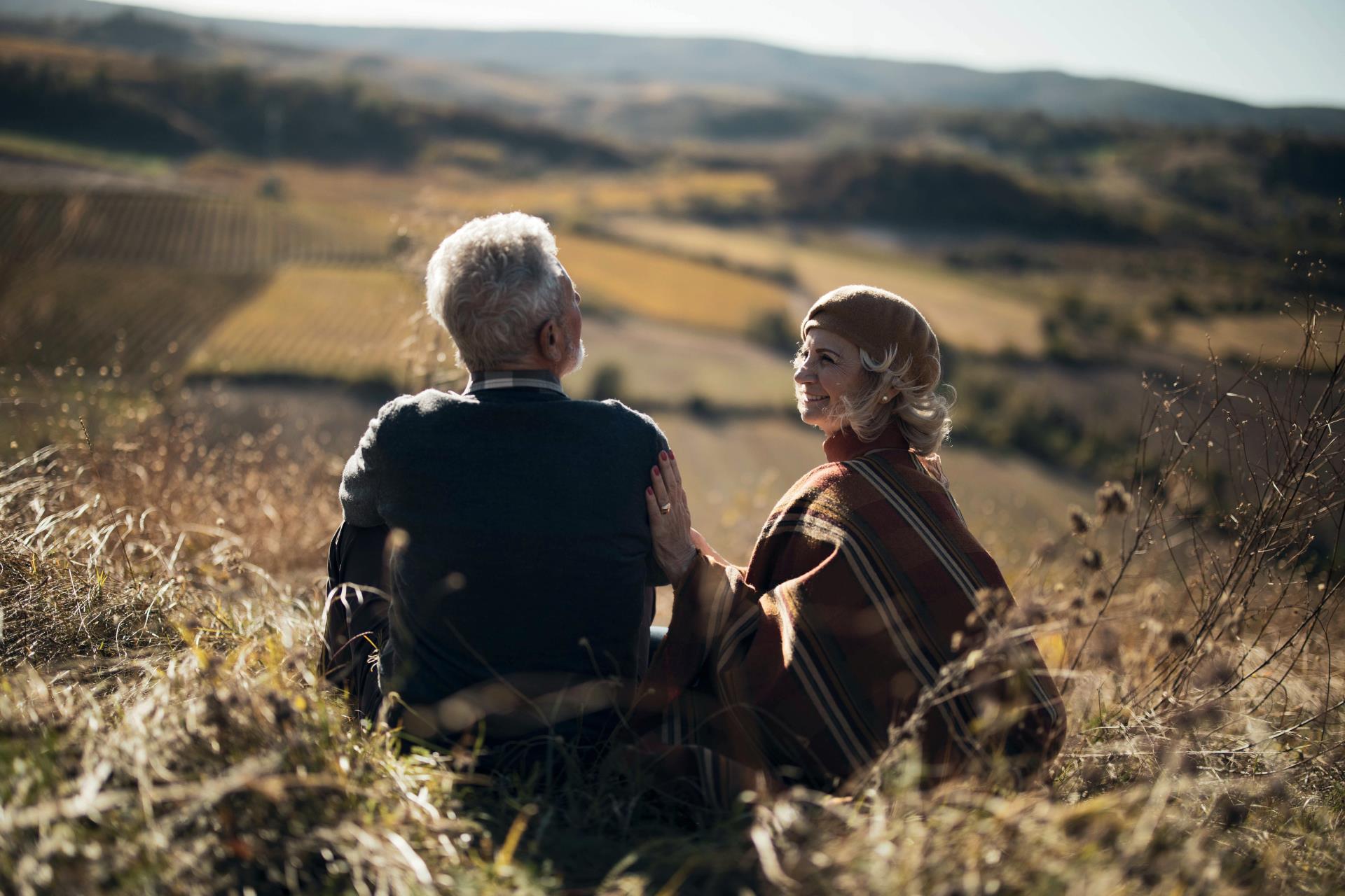 Couple enjoying afternoon sunshine in the rolling hills of the English countryside