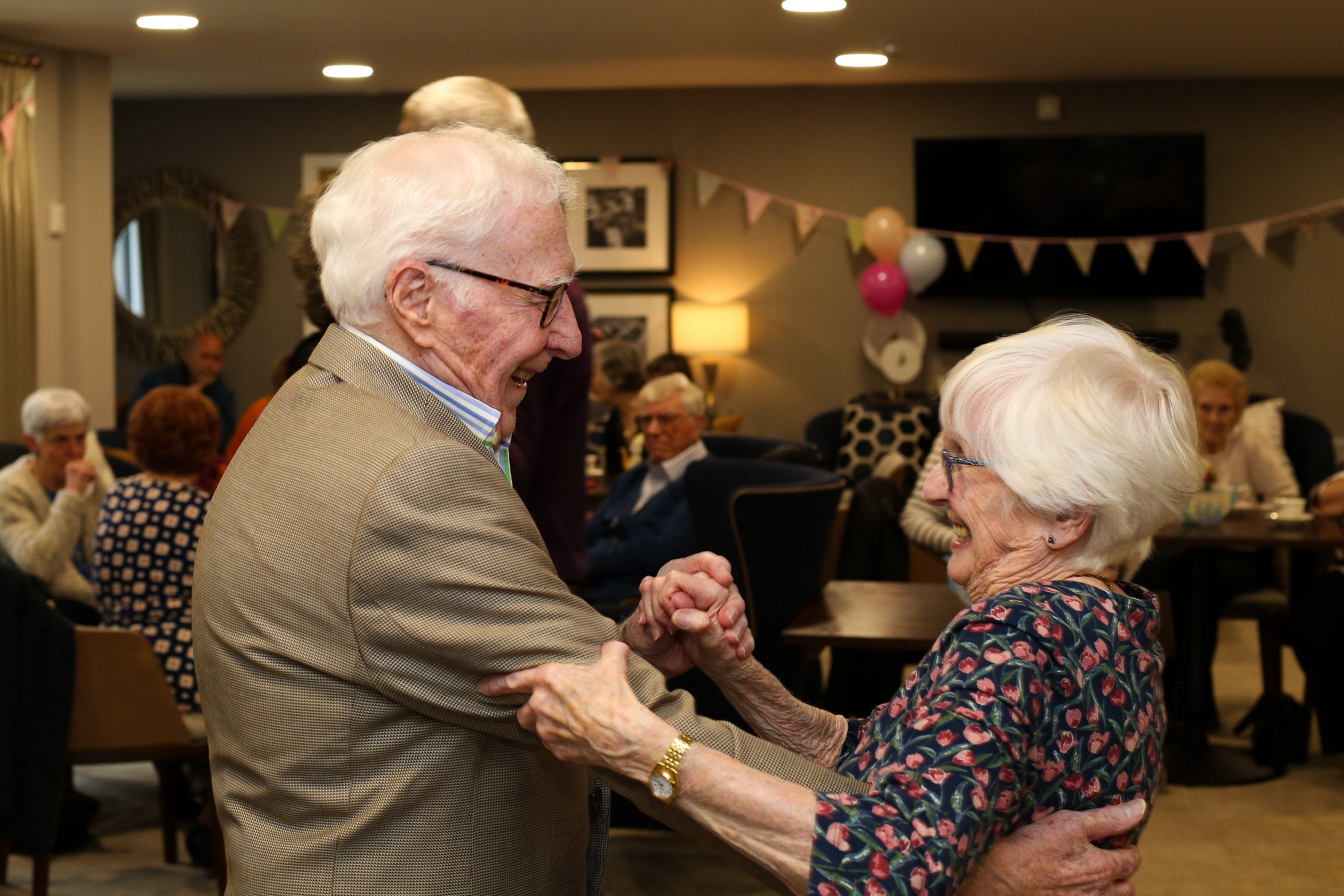 An older couple dancing at a McCarthy Stone event