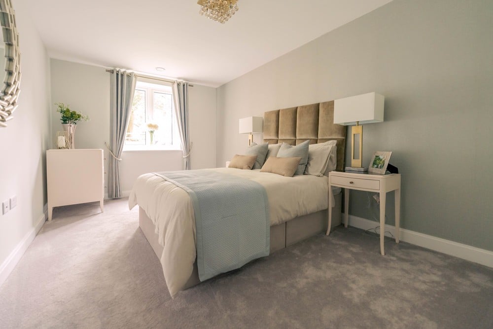 The spacious bedroom of a McCarthy Stone retirement home, featuring modern décor, contemporary furniture and plush carpet