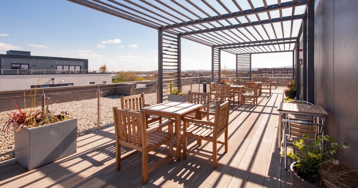 a deck with tables and chairs