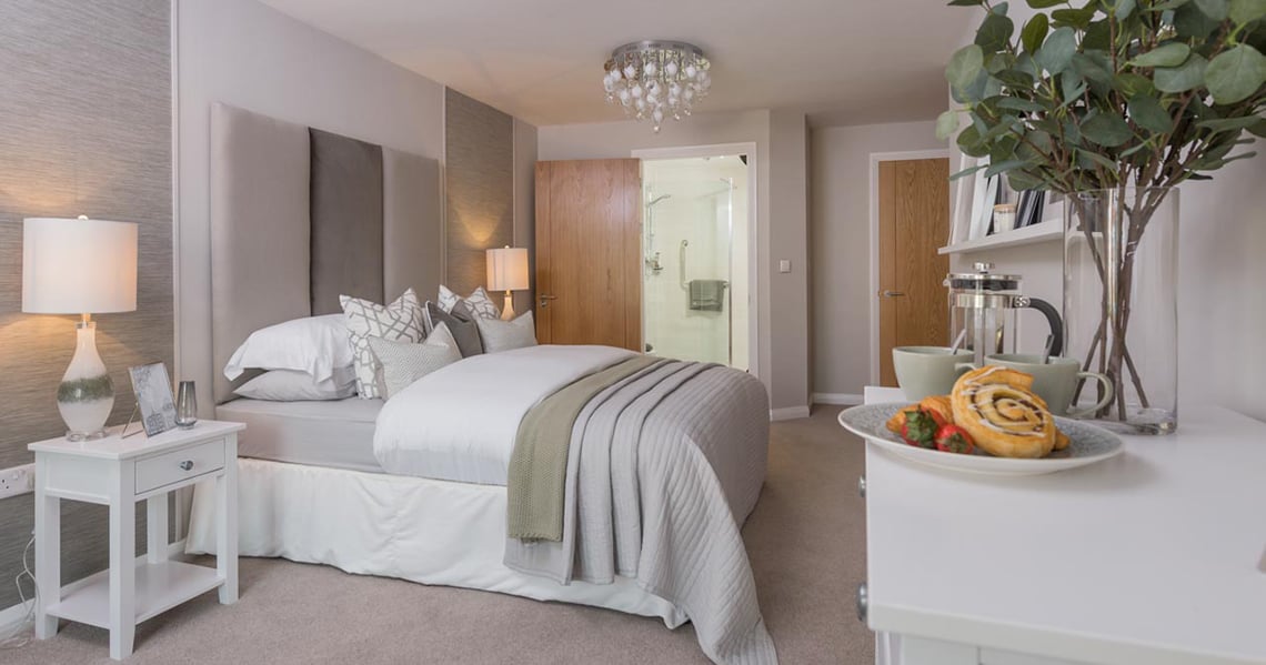 a bedroom with a bed and a table