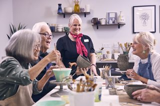 A group of retirees and the developments Estates Manager at a craft session within on of the retirement living plus developments. 