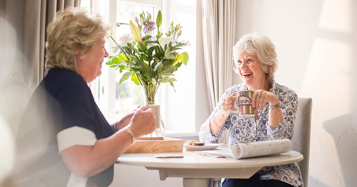 a woman laughing at a table