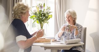 a woman laughing at a table