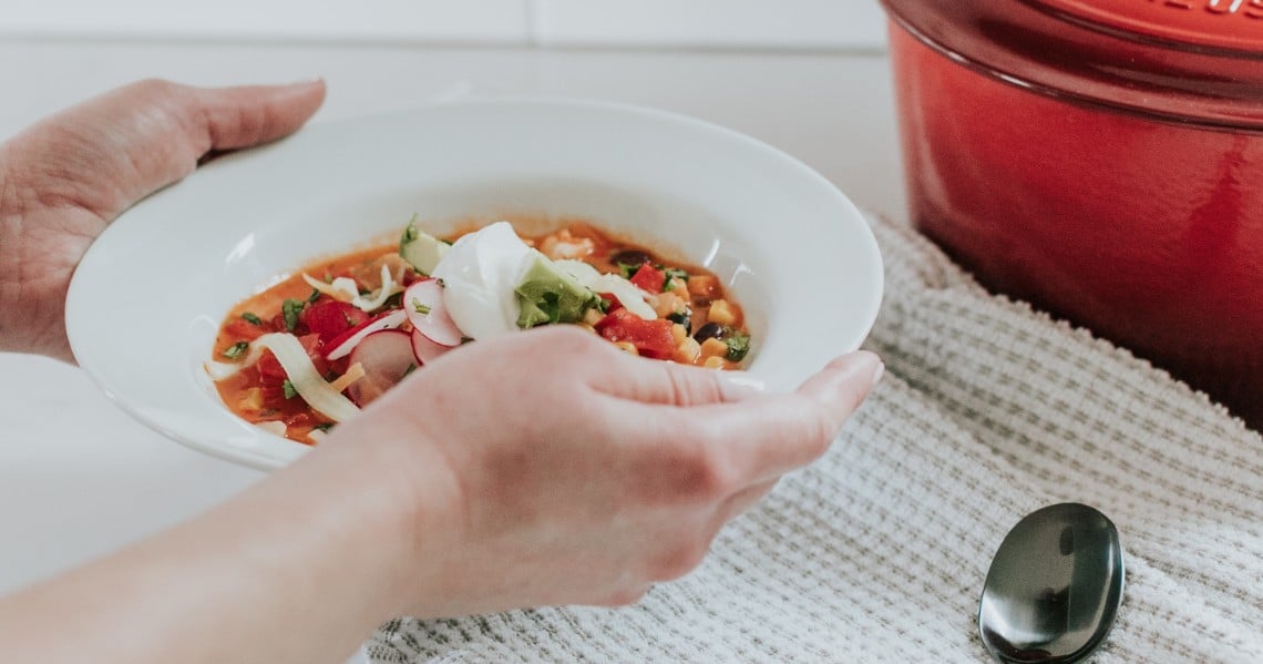 a person holding a plate of food