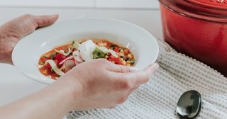 a person holding a plate of food