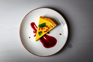 a white plate with a piece of cake on it