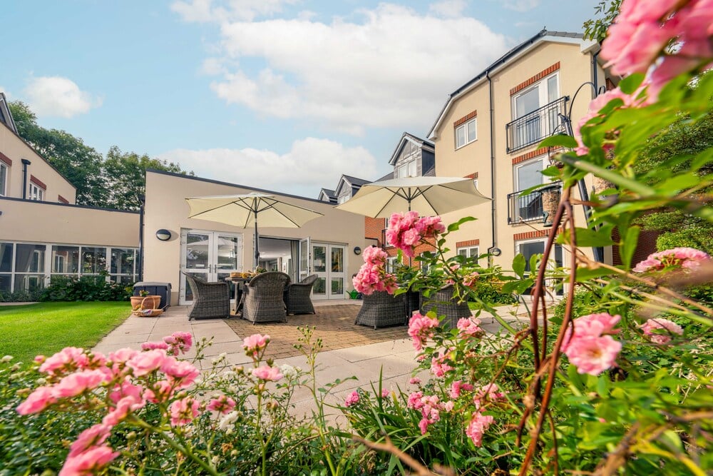 a flower bed in front of a house