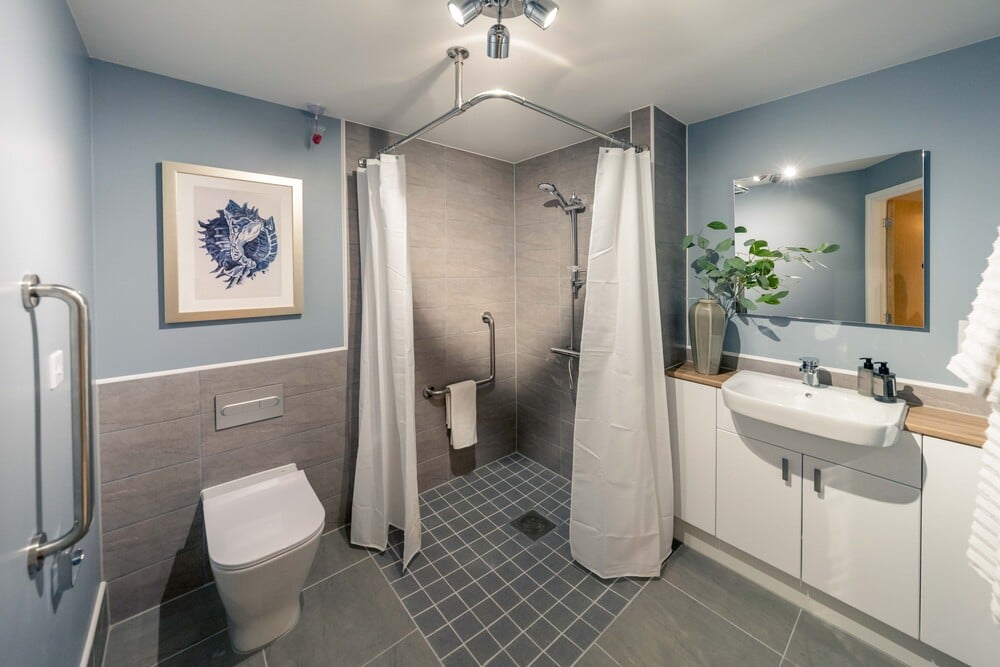 a bathroom with a shower and sink