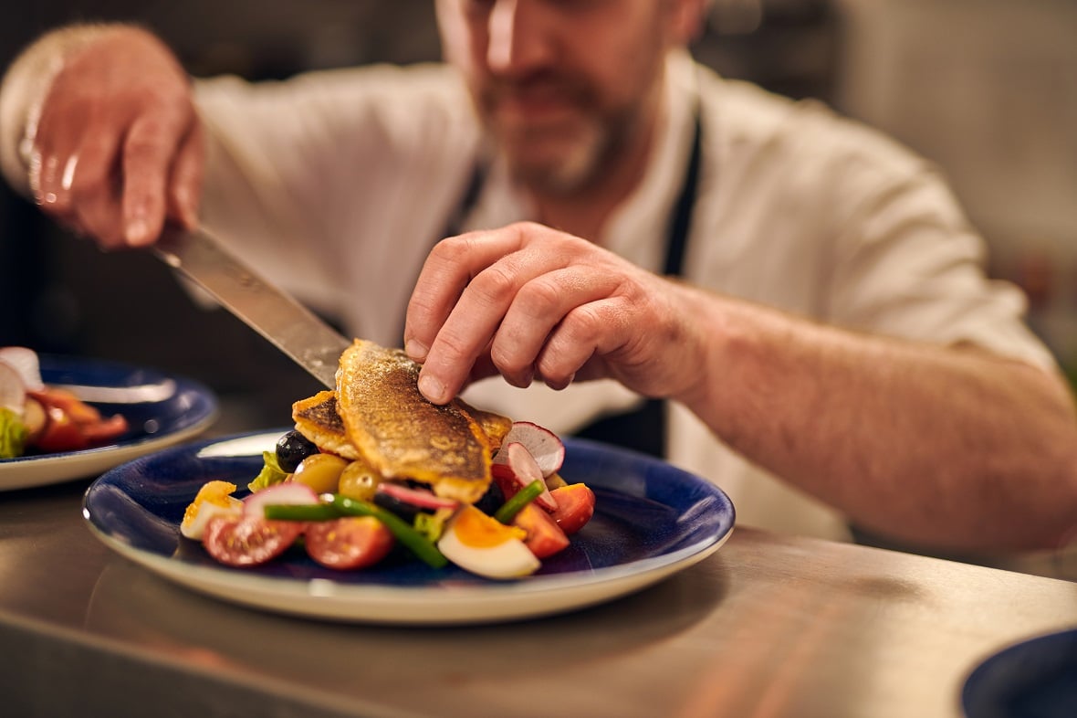 Chef plating up a fish dish