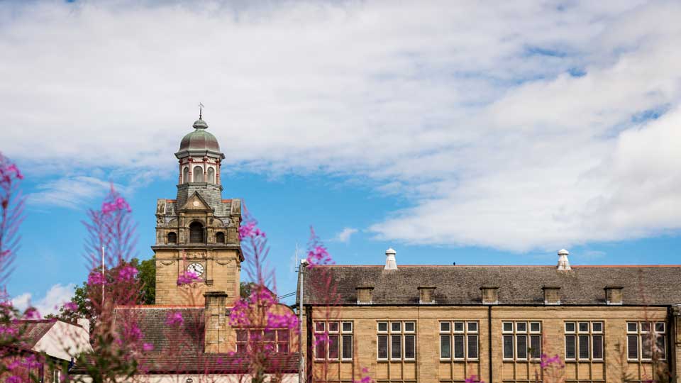 a building with a dome and a tower with a clock on it