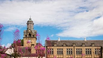 a building with a dome and a tower with a clock on it