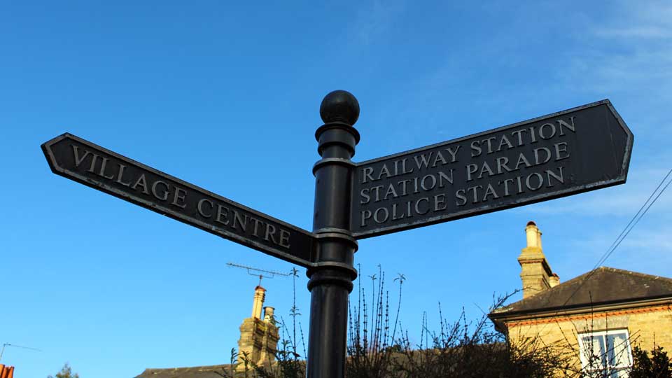 a street sign is posted at the corner of a street