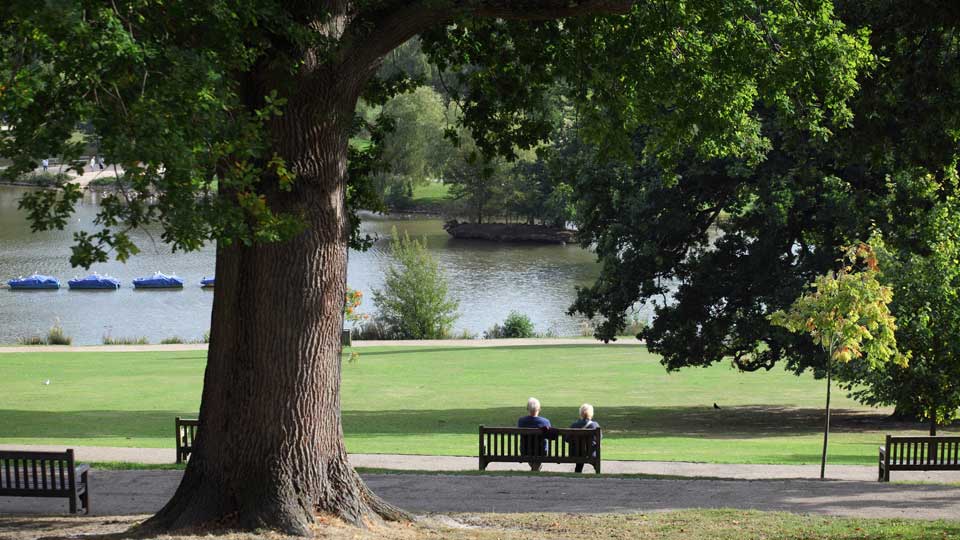 a couple of people sit on a bench