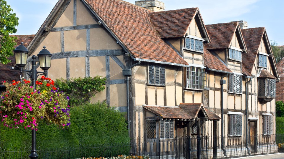 a house with a fence and flowers