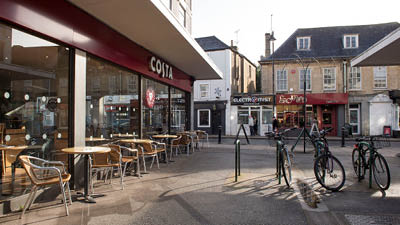 a cafe with bicycles parked outside