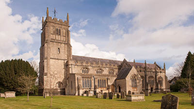 a large building with a lawn in front of it
