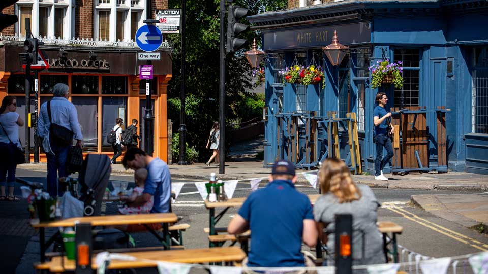 people sitting at tables outside