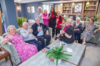 Retirees and McCarthy Stone staff raise a glass at to retirement living, at Wheatley Place