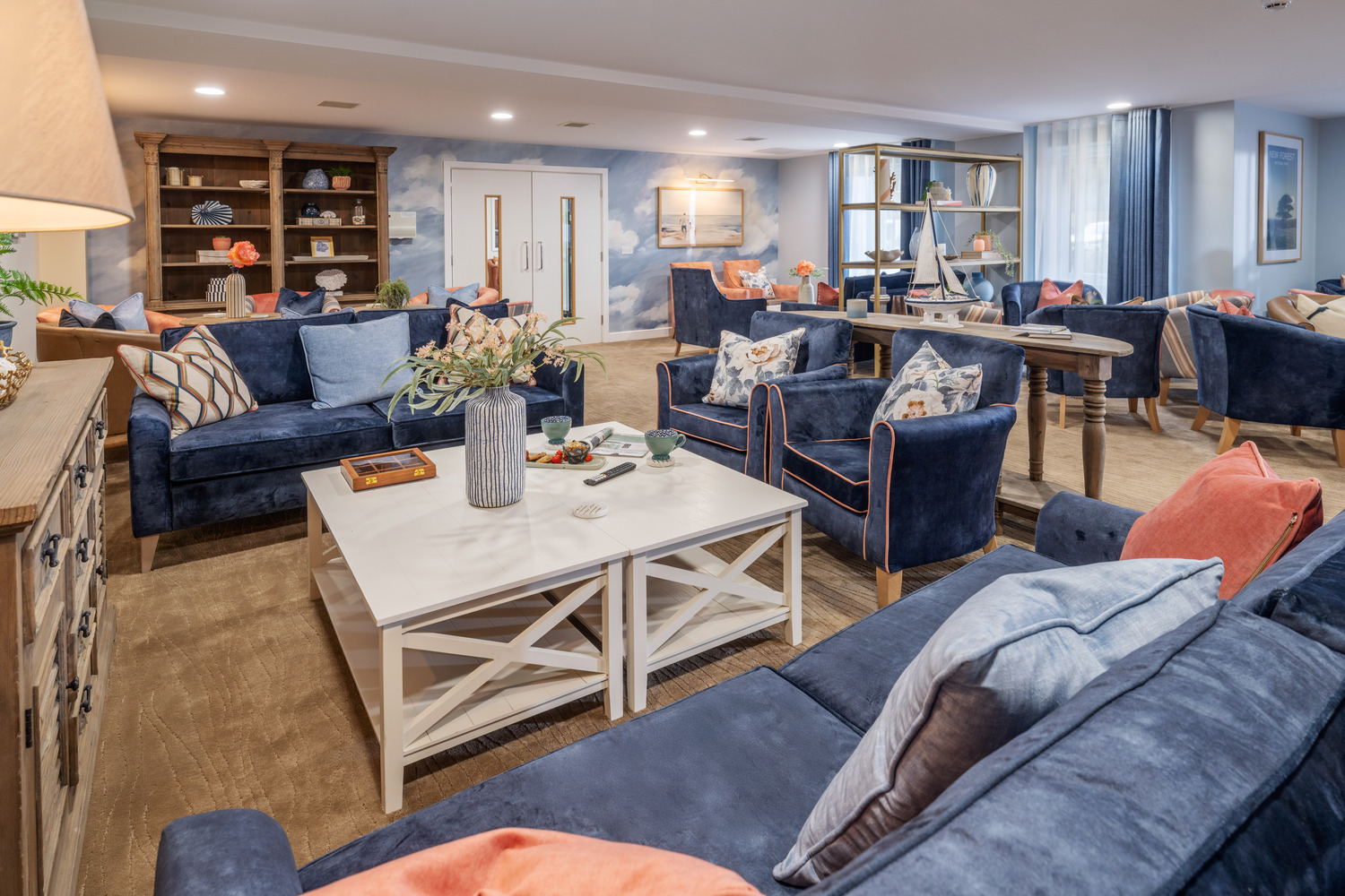 a living room with blue couches