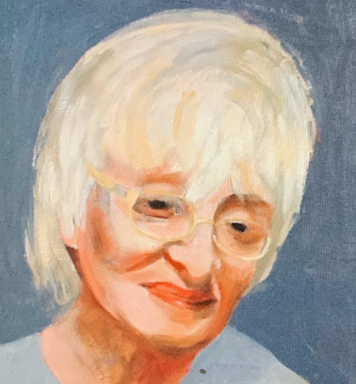 A portrait of an old lady with glasses and a blue top