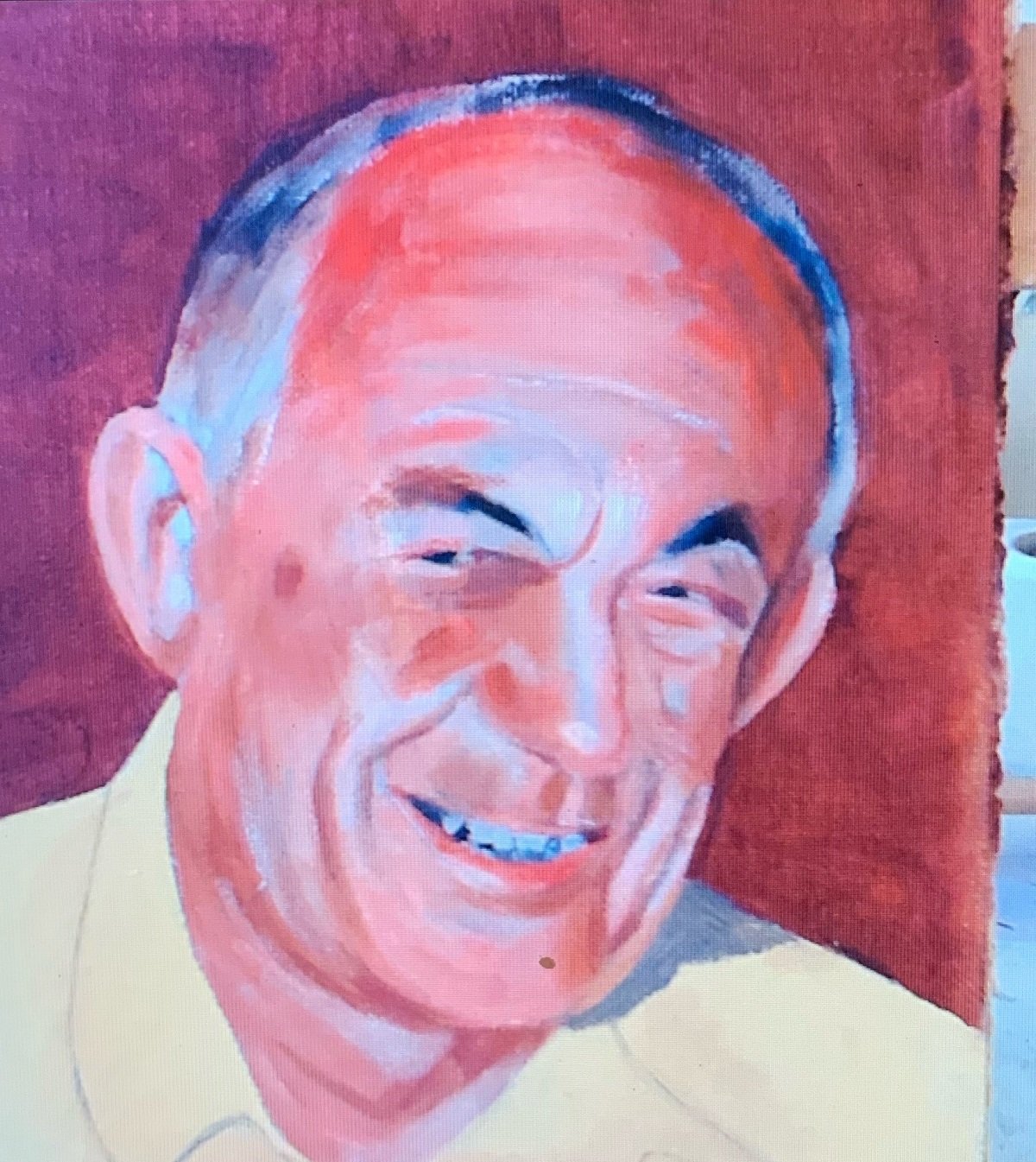 A portrait of an old man in a yellow shirt