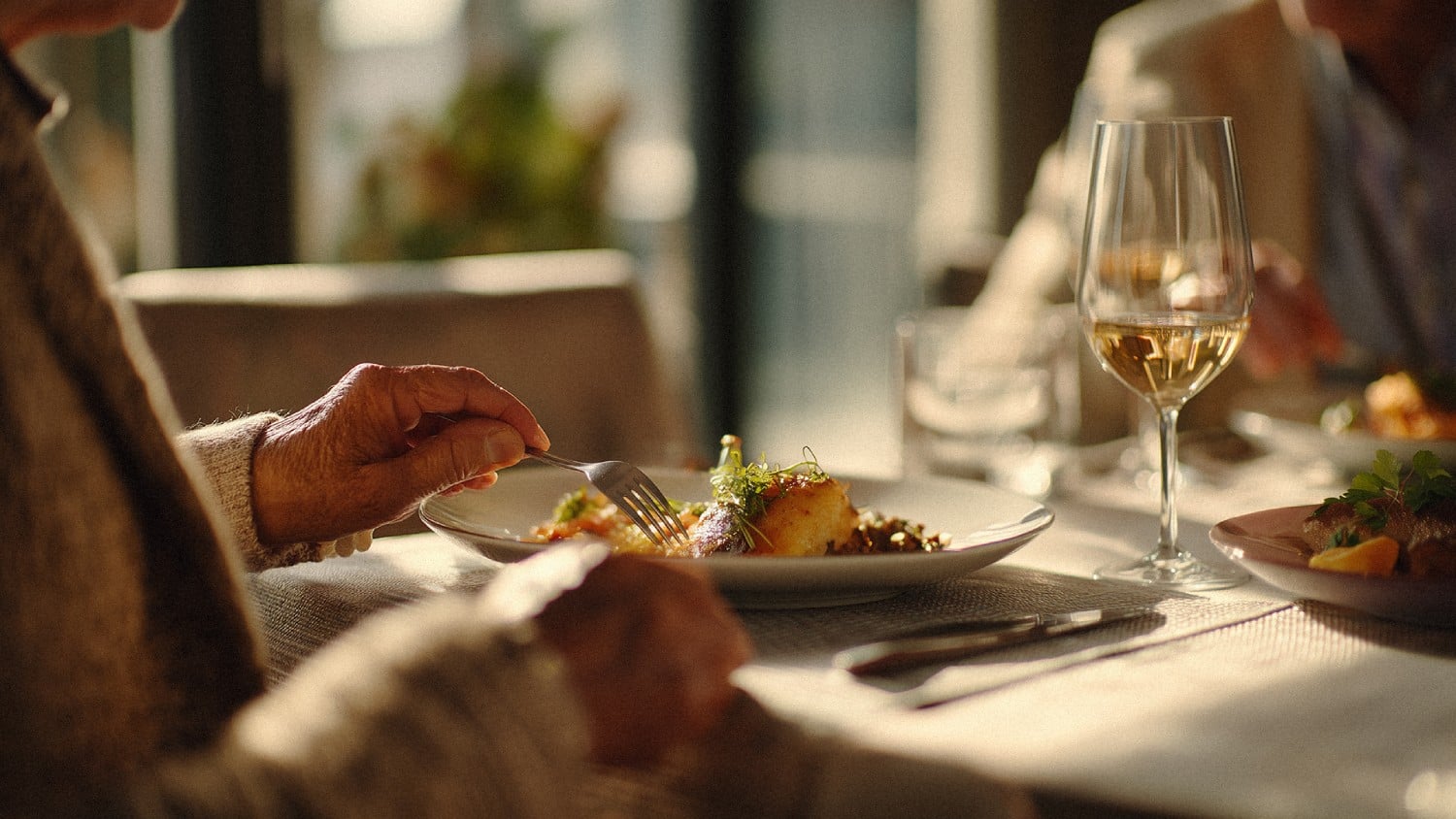 a person eating food at a restaurant