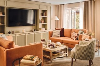 a living room with a tv and couches