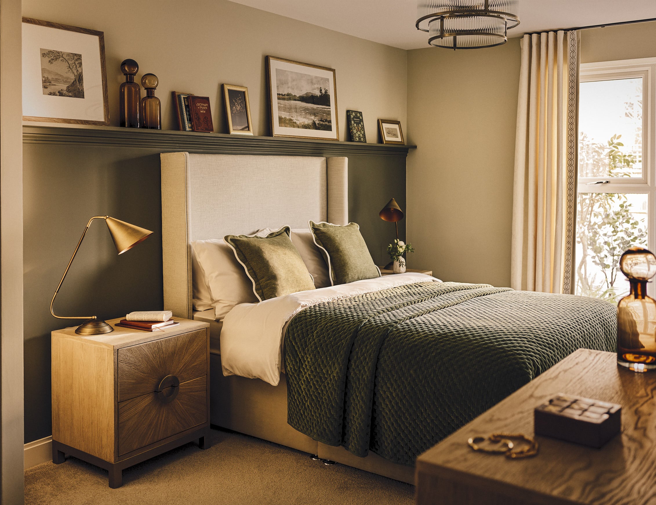a bedroom with a bed and a shelf with pictures on it