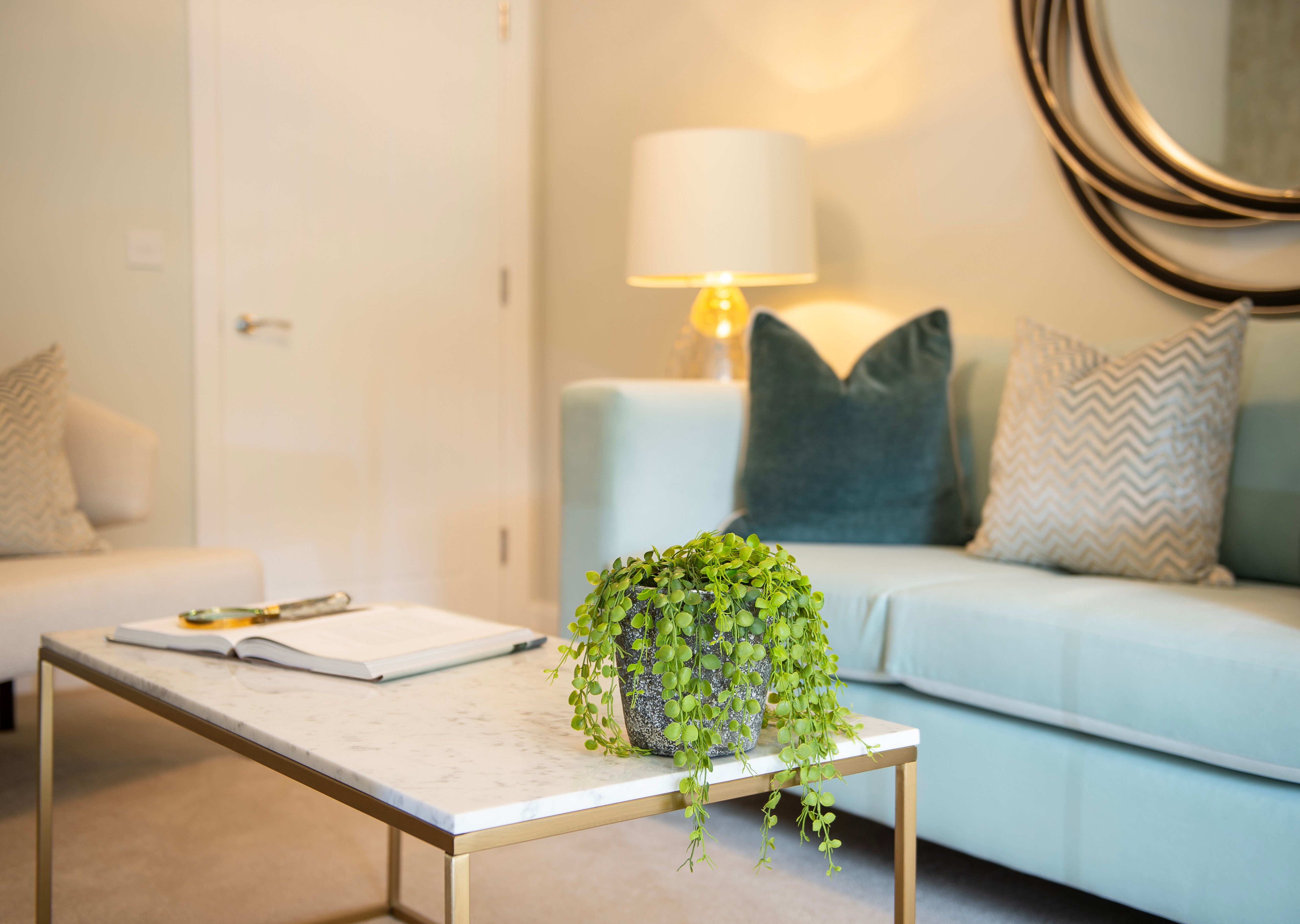 a living room with a blue couch and a coffee table
