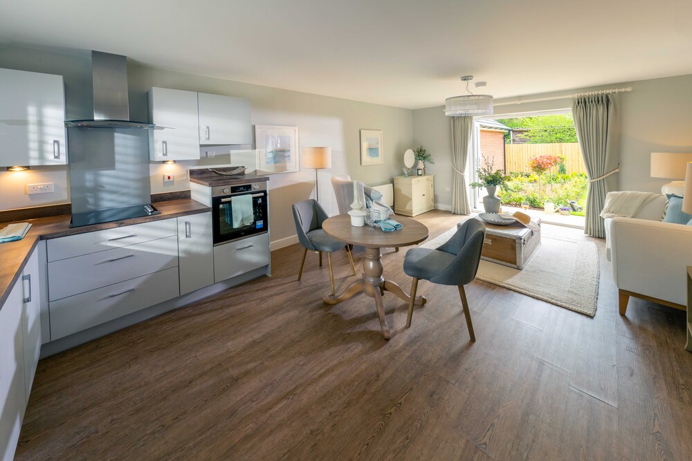 a kitchen with a dining table and chairs