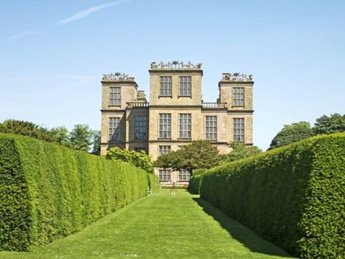 a large building with a green lawn with Hardwick Hall in the background