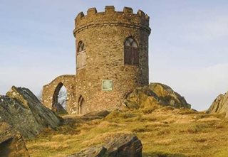 a stone building on a hill