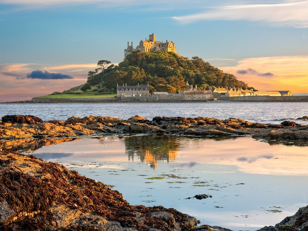 a castle on a hill by the water