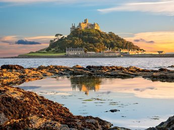 a castle on a hill by the water