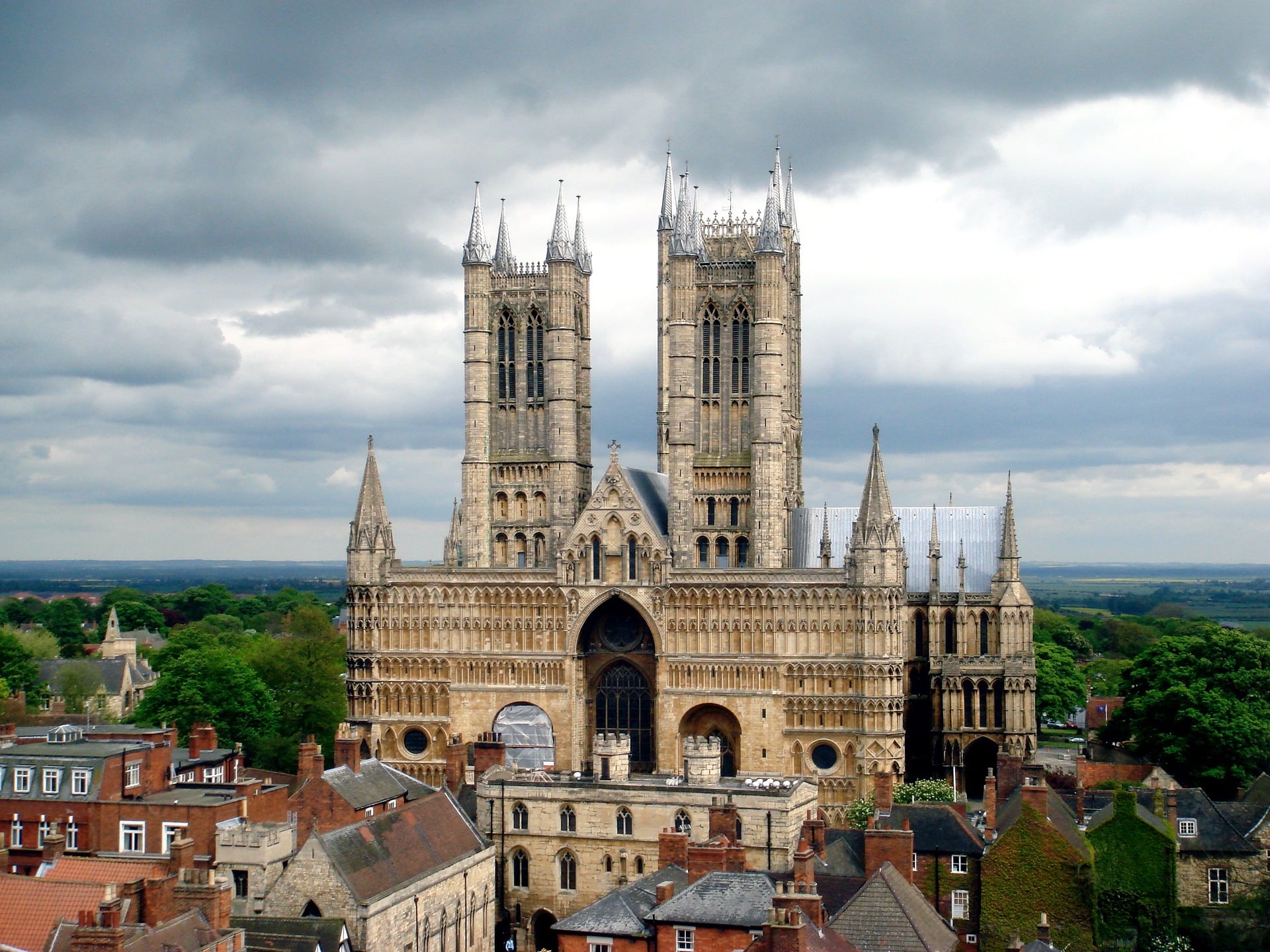 Lincoln Cathedral, with two Gothic towers and a stormy sky.