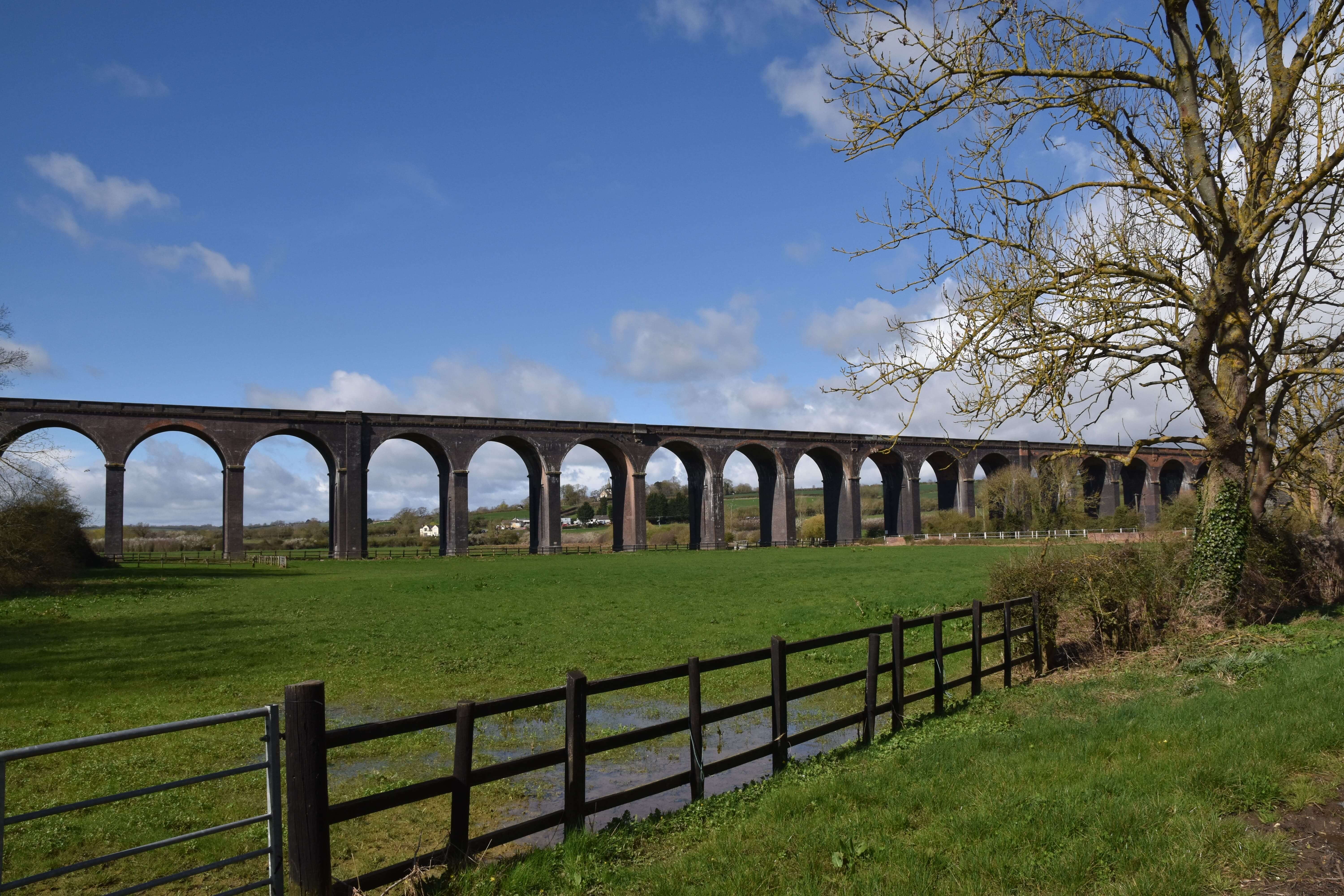 a bridge over a grassy field